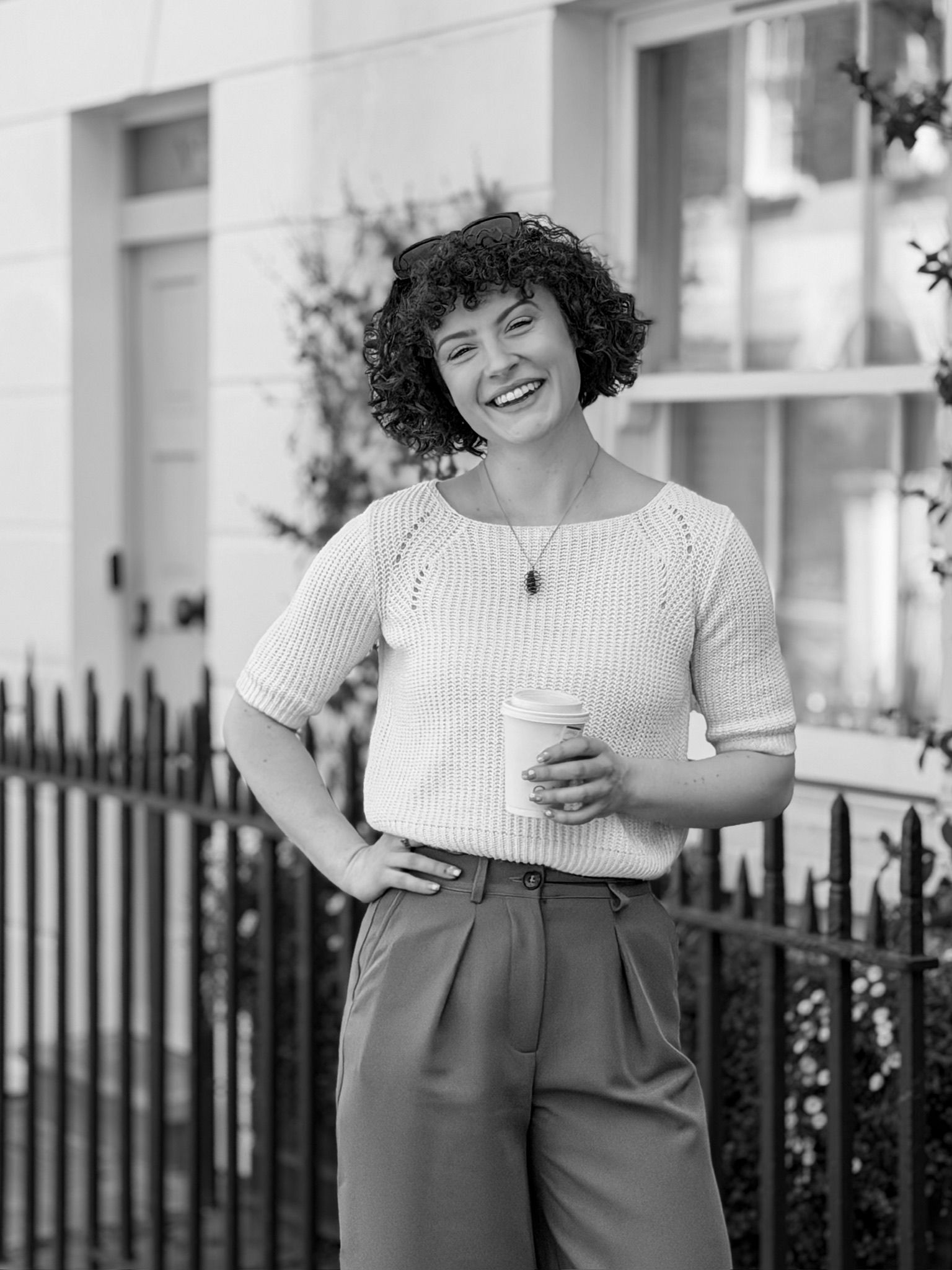 Hannah Crawford, founder of Crawford & Co, standing on a London street holding a coffee.